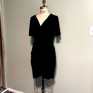 Little black dress V neck , shot sleeve and wrapped skirt. Up body lining. M